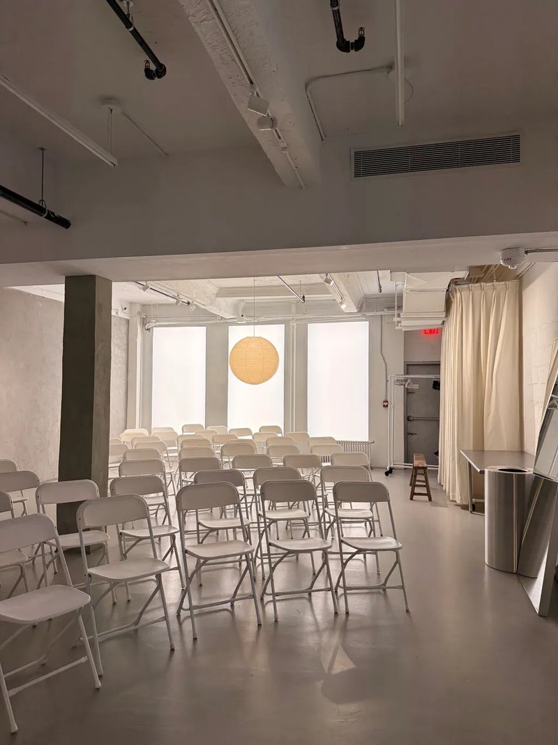Chairs set out in a daylit event space before a community event