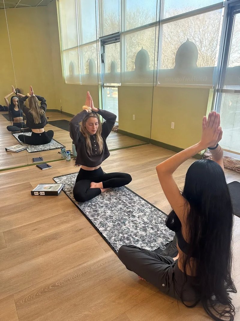 Leading a seated yoga class in a studio